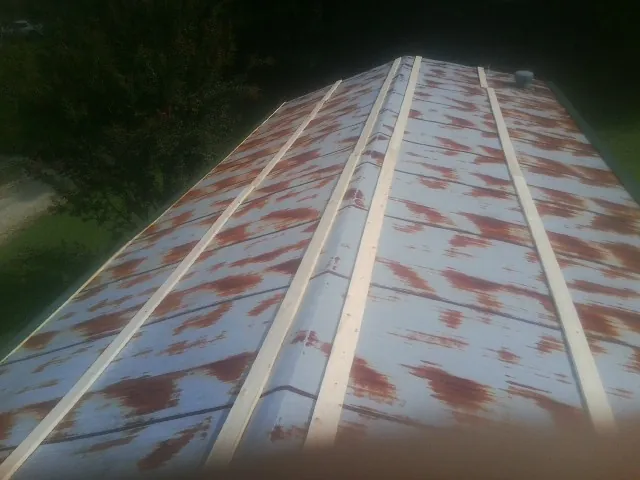 Rusted metal roof panels with new wood purlins before replacement — Storm Damage Roof Repair in Felton by Roofing Brothers